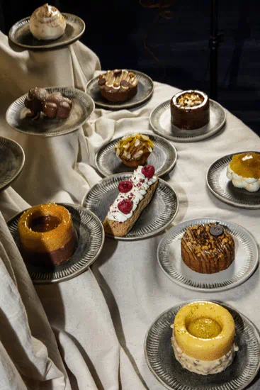 Assorted artisanal desserts on display at Yema Kitchen, a Mediterranean-inspired Canggu restaurant known for elevated sweets and handcrafted presentations.